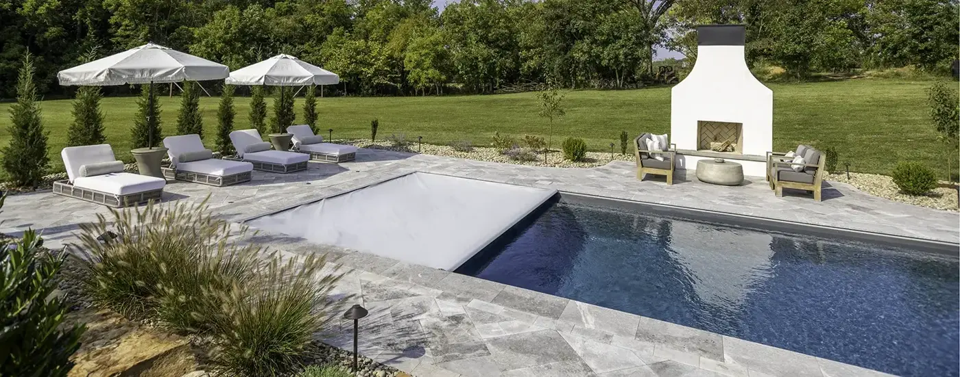 Automatic pool cover half open on a backyard pool