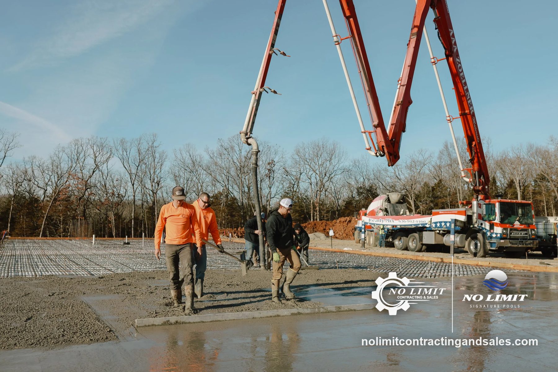 Crew in orange shirts pouring large slab over rebar grid, boom pump truck behind by No Limit Contracting & Sales