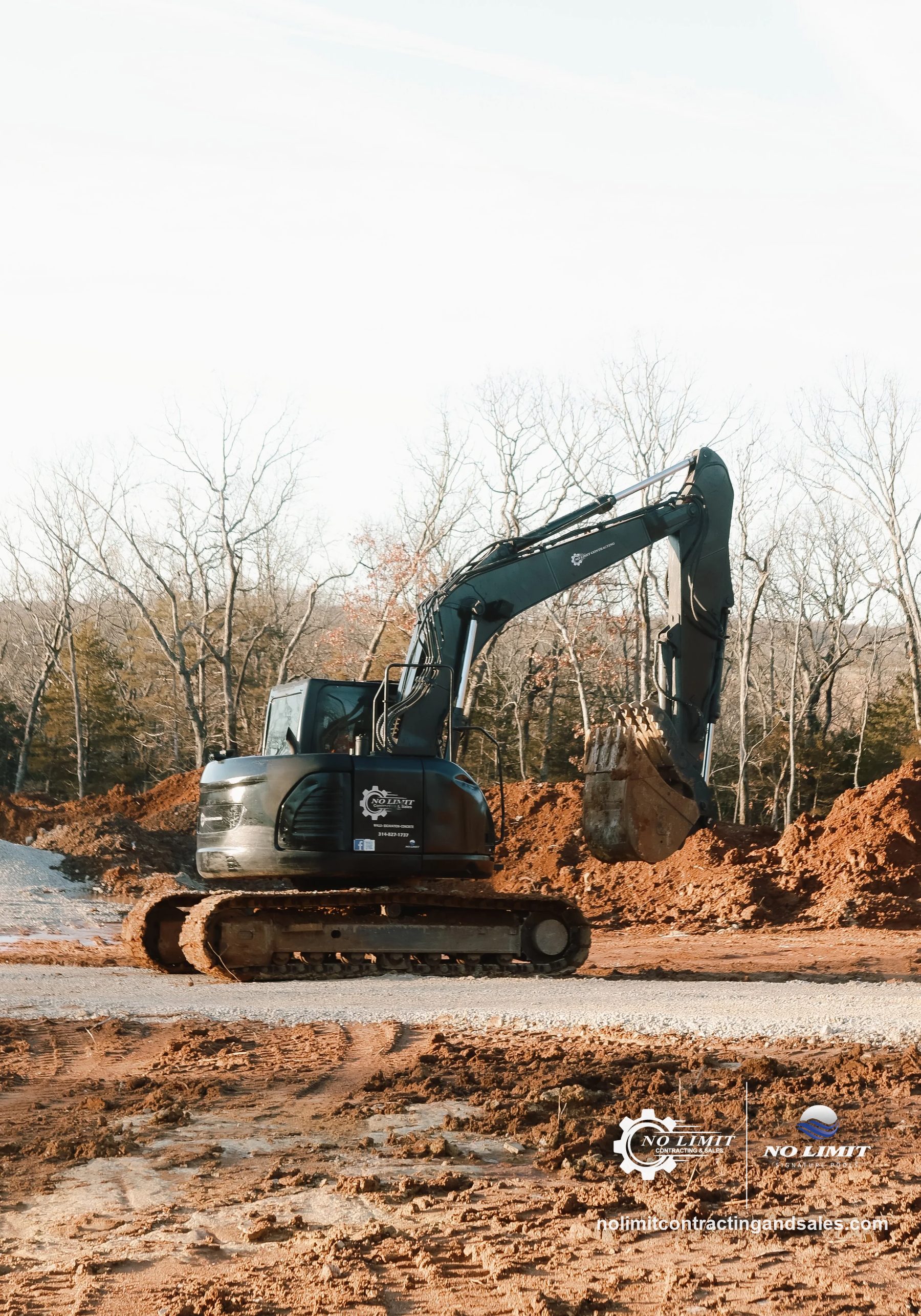 No Limit excavator digging red clay on cleared job site by No Limit Contracting & Sales