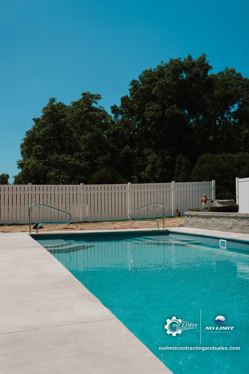 Finished rectangular fiberglass pool along a new concrete deck by No Limit Signature Pools