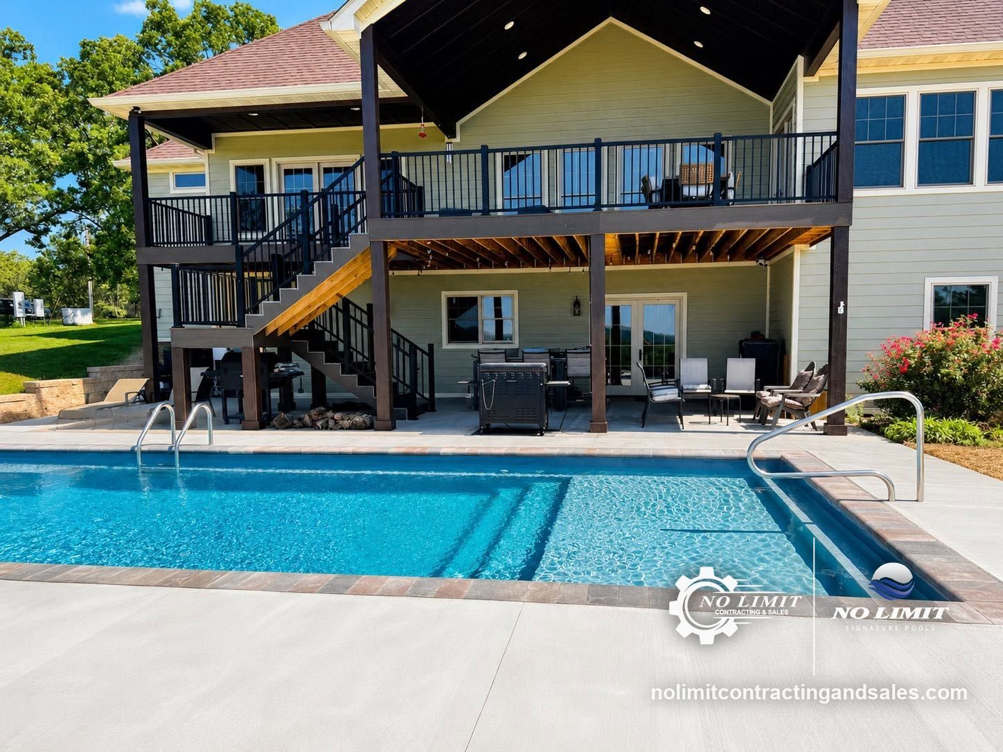 Fiberglass pool with paver coping and concrete deck below a covered two-story deck in Sullivan, MO, by No Limit Signature Pools