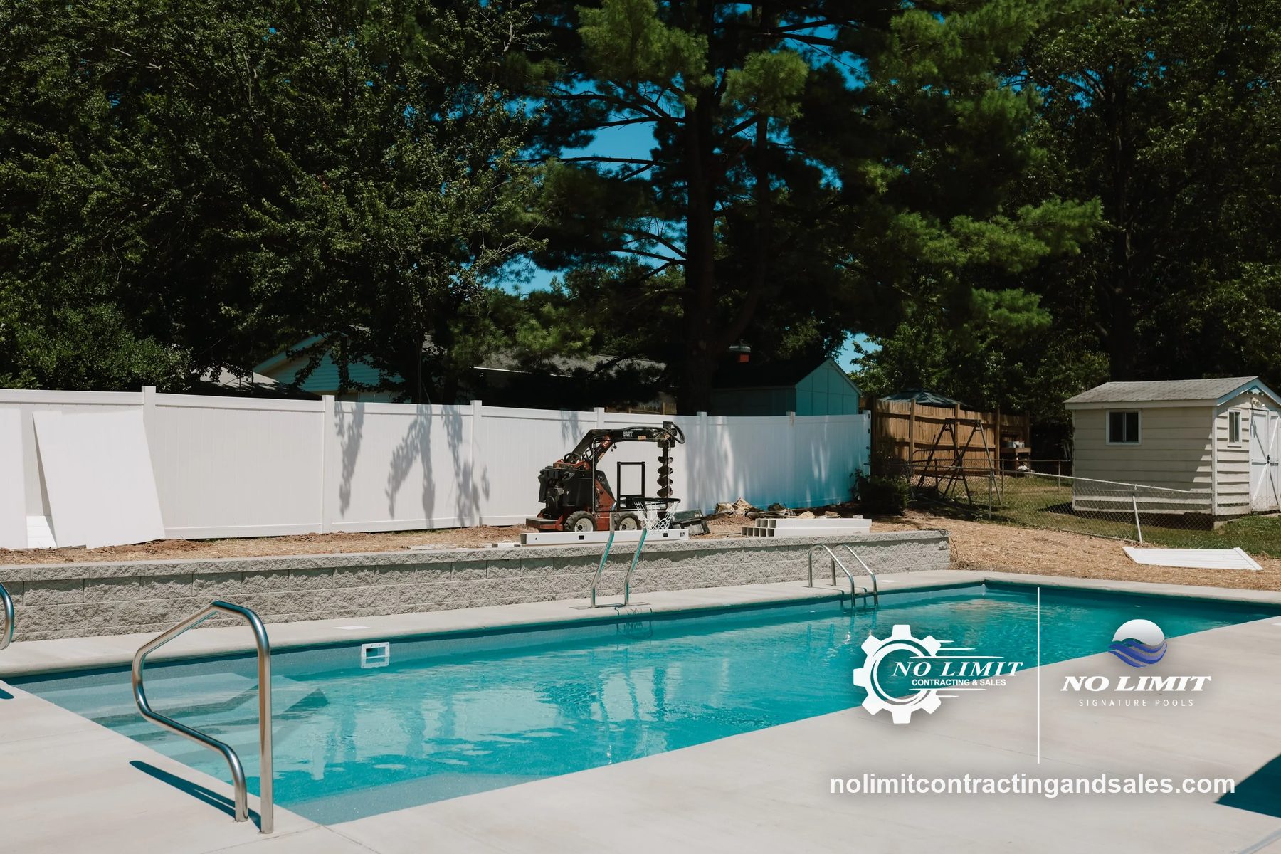 Rectangular fiberglass pool with broom-finish deck, block wall, auger machine behind by No Limit Signature Pools